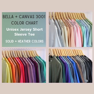 Bella + Canvas 3001 color chart showing solid and heather unisex jersey short sleeve tees on wooden hangers. Includes shades like white, heather dust, soft pink, peach, mint, kelly green, maroon, heather navy, and black.
