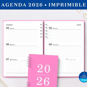 May include: A pink 2026 agenda with a spiral binding, open to display the week of January 5th. The cover of the agenda is pink with the numbers "2026" in white. The top banner reads "AGENDA 2026 • IMPRIMIBLE".