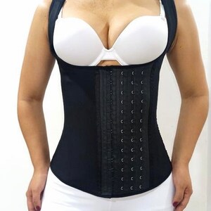 May include: Black and white corset with adjustable straps and a hook and eye closure. The corset has a smooth, satin-like finish and is designed to cinch the waist.