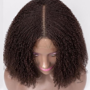 May include: A dark brown wig with tight, small curls and a center part. The wig features a sheer lace front base that sits along the hairline, showcasing a dense, textured curly hair pattern that falls to shoulder length on a mannequin head.