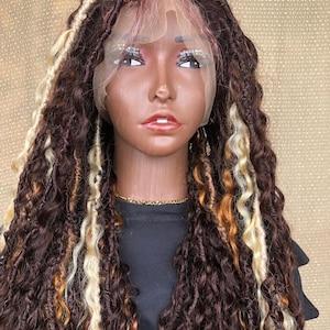 May include: A brown and blonde faux loc wig on a mannequin head. The wig features a lace front and a mix of dark brown, blonde, and orange locs. The mannequin has a dark complexion, with detailed facial features and a gold chain.