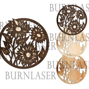May include: Three round wooden wall decorations featuring a laser-cut design of sunflowers. The design is in a dark brown wood with a lighter wood background.