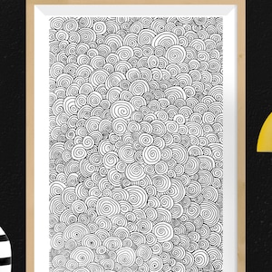 May include: A framed art print featuring a black and white spiral pattern. The artwork is composed of numerous swirling, circular shapes, creating a dense, textured design. The frame is a light brown color, and the background is black.