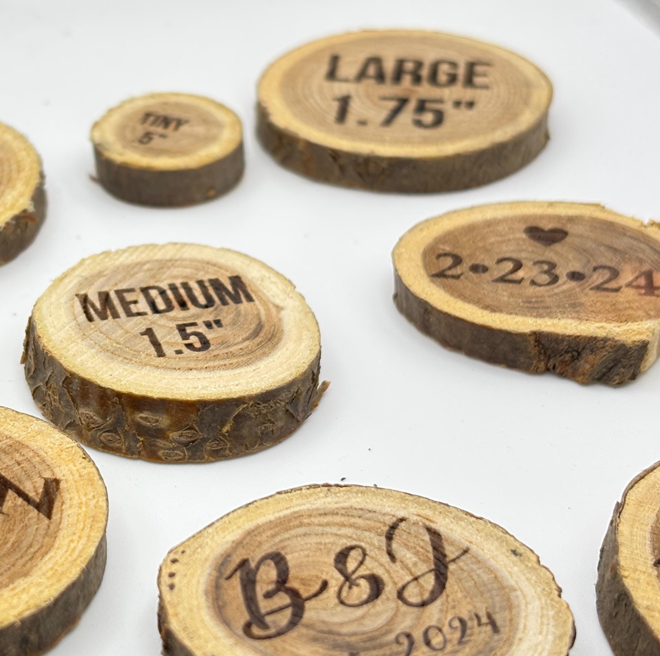 Various sizes of natural wood slices labeled as tiny, medium, and large with different engravings.