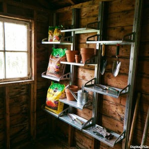 May include: A metal shelving unit in a wooden shed holds gardening supplies. The shelves display bags of potting soil, terracotta pots, hand tools, a watering can, and gardening gloves. The shed has a window on the left.