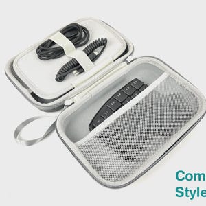 May include: A gray zippered carrying case with a light gray interior. The top section features elastic straps holding two black coiled cables. The bottom section contains a black numeric keypad and a white mesh pocket. The text Compact Style is visible.