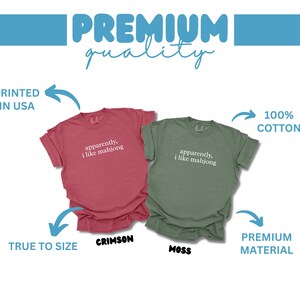 May include: Two short-sleeved t-shirts, one crimson and one moss green, with the text "apparently, I like mahjong" printed on the front. The shirts are labeled as true to size and made of premium material, printed in the USA.