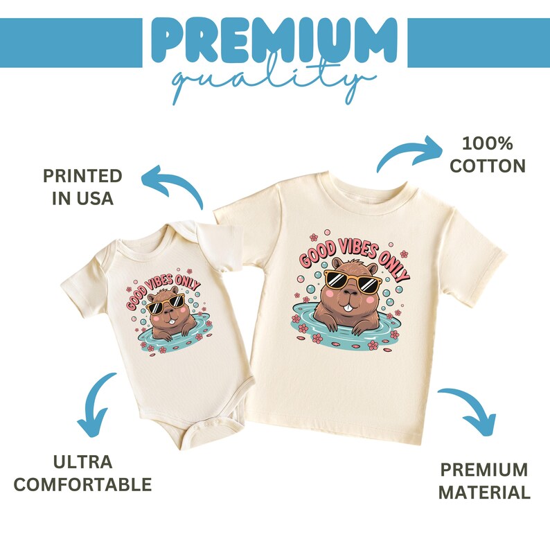 May include: Two cream-colored baby and toddler shirts. Each features a cartoon beaver wearing sunglasses in water, with the text "GOOD VIBES ONLY." The shirts are labeled "100% COTTON," "ULTRA COMFORTABLE," and "PREMIUM MATERIAL."
