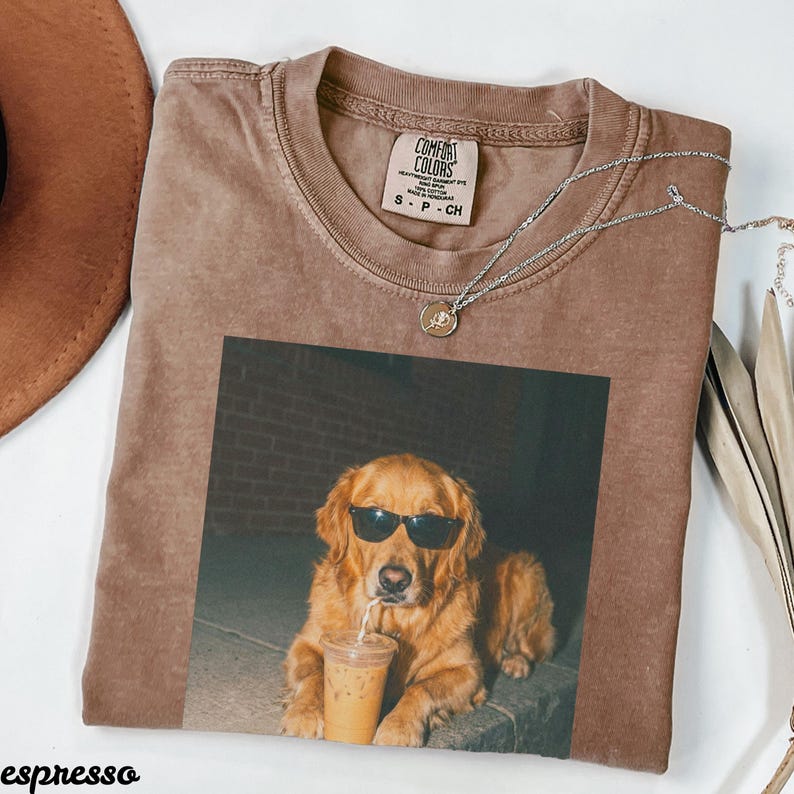 Brown t-shirt with a golden retriever wearing sunglasses and drinking from a cup.