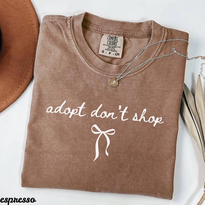 Adopt don't shop t-shirt, animal rescue tee, cute graphic top, casual shirt, adopt don't shop slogan, trendy adoption shirt