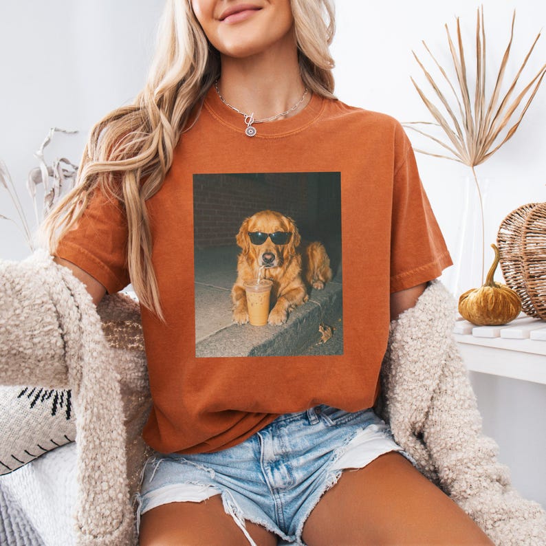 Golden retriever wearing sunglasses with a coffee drink.