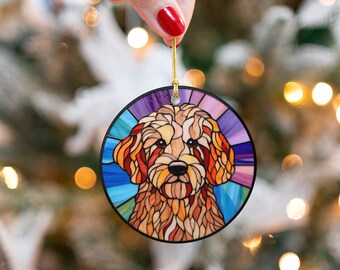 May include: A round, colorful stained glass ornament featuring a brown and white dog with a blue background. The ornament is perfect for hanging on a Christmas tree.