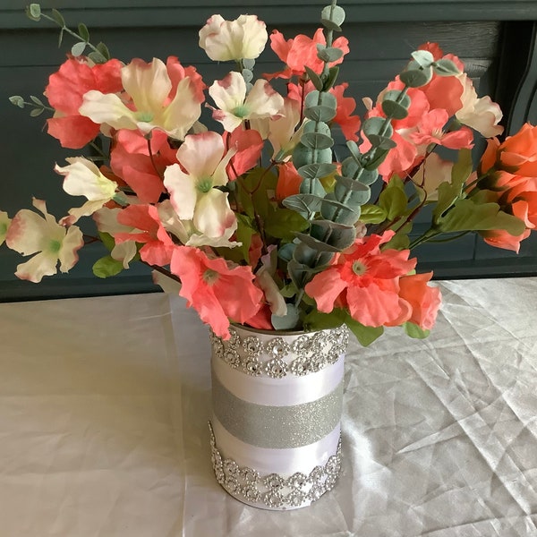 floral arrangement with peach/pink rosebuds, and peach/pink and cream blossoms