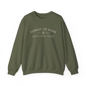 May include: A green sweatshirt with the text "Forest of Dean National Park" and a logo of a deer with antlers. The text also includes "Est. 2007".