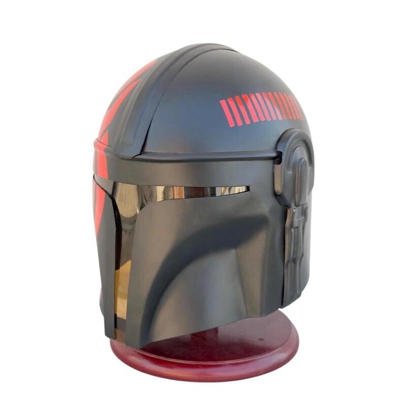 May include: A black helmet with red accents, featuring a visor and a series of red lines on the top. The helmet is displayed on a red stand, showcasing a futuristic design.