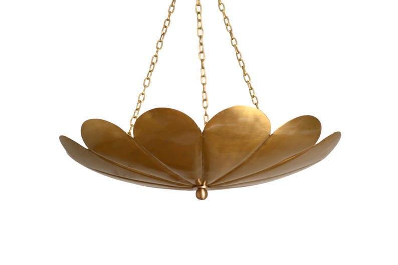 May include: A brass-colored, petal-shaped chandelier with a central pendant. The light fixture is suspended by three chains. The design features overlapping, curved elements, creating a floral appearance. The overall aesthetic is elegant and modern.