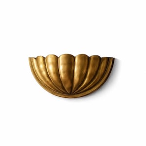 May include: A semi-circular wall sconce featuring a metallic gold finish and a scalloped shell-like design with vertical ridges radiating from the center base. The fixture has a smooth, curved edge and a polished, reflective surface texture.