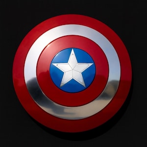 May include: A circular shield in red, silver, and blue, featuring a central white star on a blue disc. The shield has a glossy red outer ring and a silver band. The design is reminiscent of a superhero's iconic accessory.