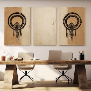 May include: A minimalist home office with a wooden desk and two chairs. Three framed prints with black and white geometric designs hang on the wall. The room is decorated with wooden sculptures, a vase with dried plants, and a woven basket.