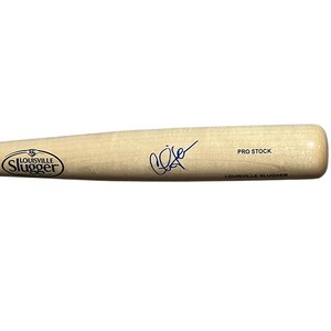 May include: A light-colored wooden baseball bat with the Louisville Slugger logo and a signature. The words "PRO STOCK" and "LOUISVILLE SLUGGER" are printed on the bat.