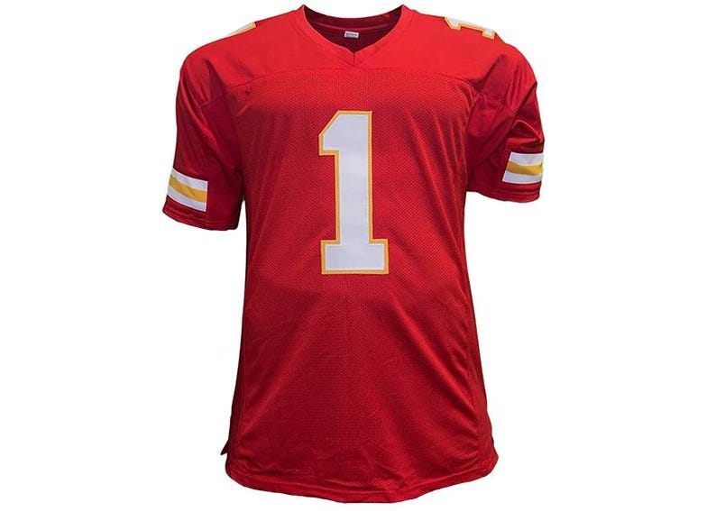 May include: A red football jersey with the number 1 in white and a yellow outline. The jersey has a V-neck and yellow and white stripes on the sleeves. The jersey is made of a mesh material.