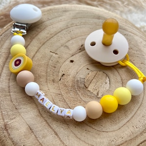 Personalized pacifier clip for girl or boy with eye pattern, yellow in color and yellow thread