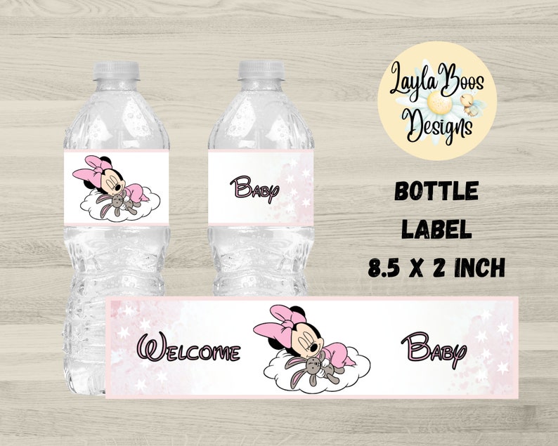 May include: Water bottle labels with a Minnie Mouse theme. The labels feature Minnie Mouse in a pink bow and dress, sleeping on a cloud with a stuffed bunny. The labels also include the word "Baby" and "Welcome". The label size is 8.5 x 2 inches.