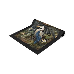 A William Morris inspired table runner featuring the graceful heron (or egret). This elegant piece brings botanical wildlife art to life, perfect for elevating your table setting and enhancing your dining room decor with nature-inspired design.