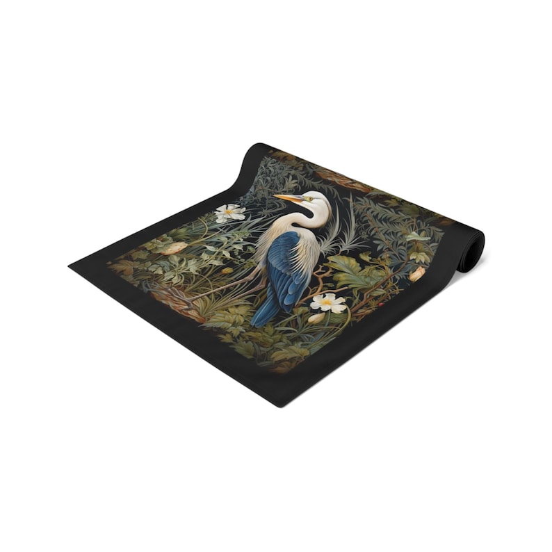 A William Morris inspired table runner featuring the graceful heron (or egret). This elegant piece brings botanical wildlife art to life, perfect for elevating your table setting and enhancing your dining room decor with nature-inspired design.