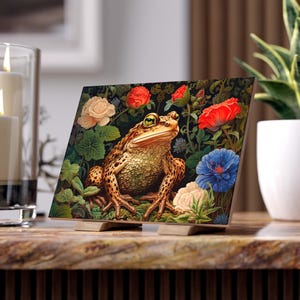 May include: A brown and yellow toad with green eyes sits on a bed of green leaves and colorful flowers. The flowers include red, white, and blue blooms. The toad is looking directly at the viewer.