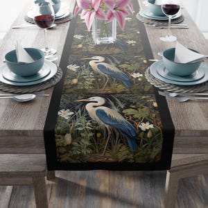 A William Morris inspired table runner featuring the graceful heron (or egret). This elegant piece brings botanical wildlife art to life, perfect for elevating your table setting and enhancing your dining room decor with nature-inspired design.