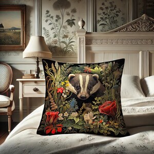 May include: Black square throw pillow featuring a badger surrounded by colorful flowers and foliage. The badger has a white and black striped face. Red roses and other flowers are visible. The pillow is on a white bed.