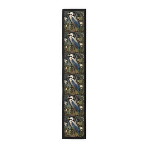 A William Morris inspired table runner featuring the graceful heron (or egret). This elegant piece brings botanical wildlife art to life, perfect for elevating your table setting and enhancing your dining room decor with nature-inspired design.