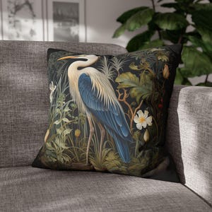 A William Morris inspired pillow featuring a Heron, perfect for Victorian and botanical decor. This decorative cushion fits beautifully on a couch, bed, or armchair, adding a touch of natural elegance and charm to indoor settings.