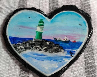 Green lighthouse on slate heart