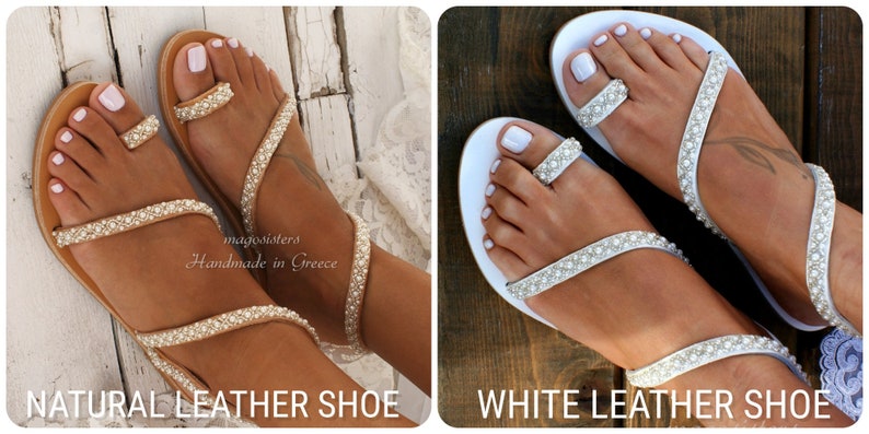 May include: Two pairs of women's sandals with a toe ring and ankle strap. The sandals are decorated with white pearls and are available in natural leather and white leather. The sandals are handmade in Greece.