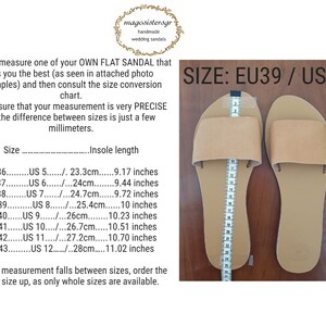 May include: A pair of tan leather flat sandals with a size chart showing the corresponding European and US sizes. The sandals are laid out on a wooden surface. The text on the chart reads "SIZE: EU39 / US8".