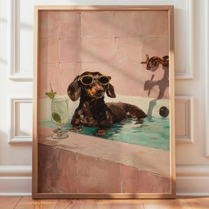 May include: A framed print of a dachshund wearing sunglasses, relaxing in a bathtub filled with water. A cocktail with a lime garnish sits nearby. The bathroom walls are pink.