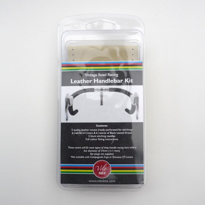 May include: Vintage Road Racing Leather Handlebar Kit packaging with two tan leather handlebar covers, black waxed thread, and needles.  The kit includes instructions for installing the covers on a drop handlebar.