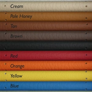 May include: A close-up of 11 different colored leather straps. The colors are white, cream, pale honey, tan, brown, black, red, orange, yellow, blue, and celeste.
