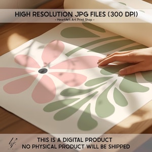 May include: A digital download of a printable art print featuring a pink flower and green leaves. The print is designed in a minimalist style and is perfect for adding a touch of nature to your home decor.