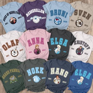 May include: A set of 10 t-shirts featuring characters from the Disney movie Frozen. Each shirt has a different character and a college-style design with the character's name and the year 2013.