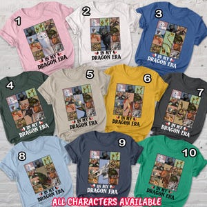 May include: A collection of ten short-sleeved t-shirts in various colors, each featuring a graphic design with dragon characters and the text "IN MY DRAGON ERA." The phrase "ALL CHARACTERS AVAILABLE" is printed at the bottom.