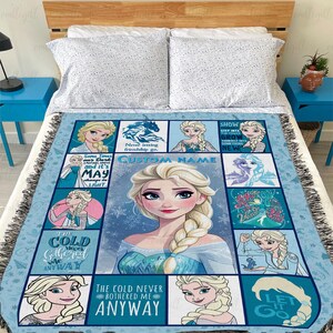 May include: A woven throw blanket featuring a grid of multiple illustrations of a blonde character with a long braid, set against a light blue background with snowflake patterns. The blanket includes text such as The cold never bothered me anyway.