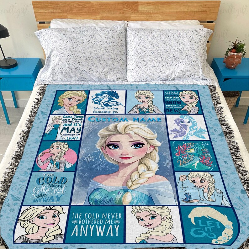 May include: A woven throw blanket featuring a grid of multiple illustrations of a blonde character with a long braid, set against a light blue background with snowflake patterns. The blanket includes text such as The cold never bothered me anyway.