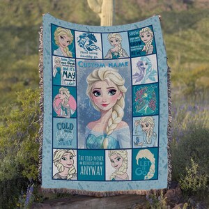 May include: A light blue woven throw blanket featuring a collage of Elsa from Frozen, including a large central portrait, multiple smaller character illustrations, snowflake patterns, and text such as The Cold Never Bothered Me Anyway and Let It Go.