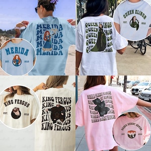 May include: Collection of t-shirts featuring characters from a movie. The shirts are in various colors, including light blue, white, and pink. Each shirt has a different design, with text and illustrations of characters like Merida, Queen Elinor, King Fergus, and Harris Hubert Hamish.