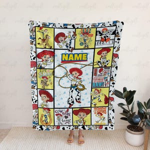 May include: A rectangular fleece blanket featuring a grid of Jessie the Cowgirl from Toy Story in various poses. The design includes the text NAME, TIME TO SHINE, YEEHAW, and COW GIRL AT HEART. The border has a black and white cow print pattern.
