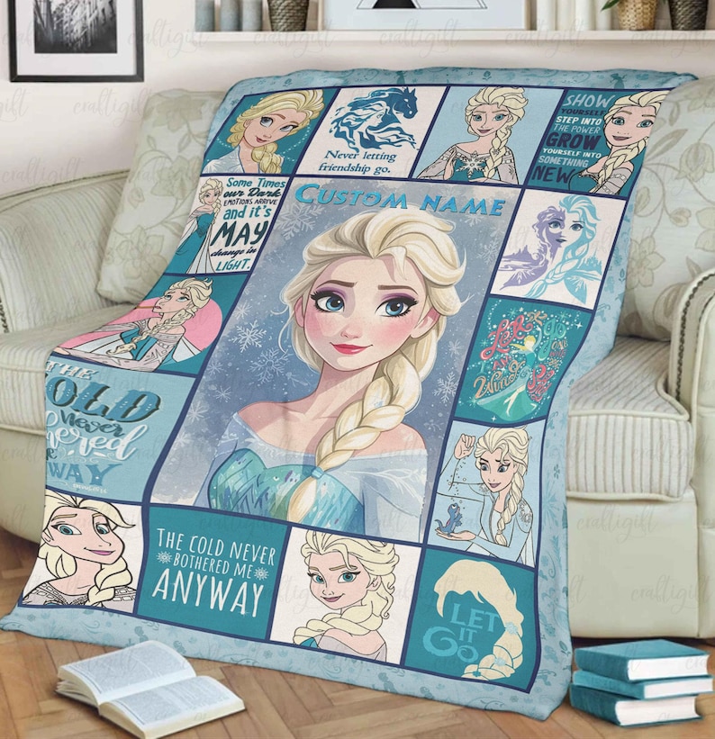 May include: A light blue and white fleece blanket featuring a collage of Elsa from Frozen, including a large central portrait, various smaller character illustrations, snowflake patterns, and text such as "The cold never bothered me anyway."