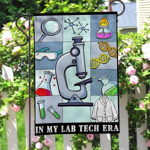 May include: A garden flag with a science theme, featuring a microscope, beakers, and molecular diagrams. The flag is divided into squares with various lab-related illustrations. Text at the bottom reads "IN MY LAB TECH ERA."